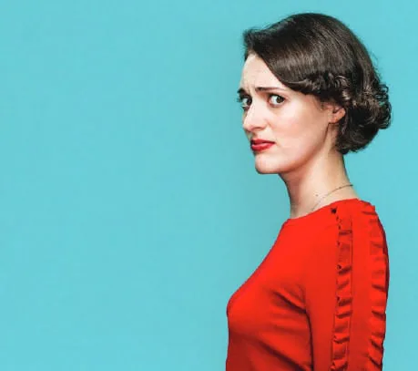 A woman in a red dress against a blue wall