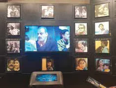 A gallery wall of screens and framed pictures