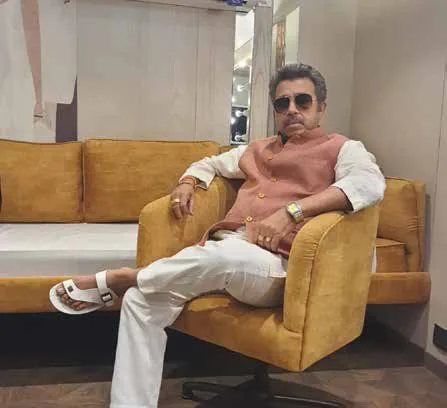 Pankaj Jha seated in a yellow armchair, wearing sunglasses