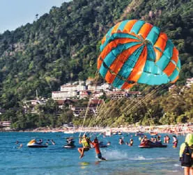 Parasailing over a busy beach