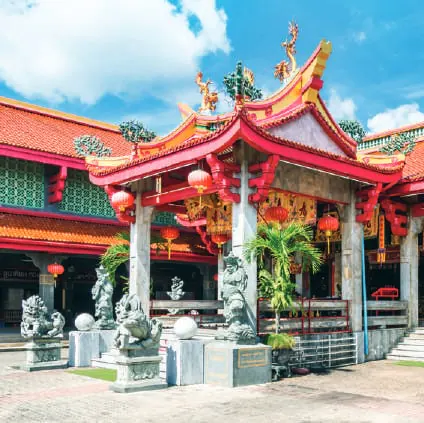 A red and gold Chinese shrine with ornate roofs
