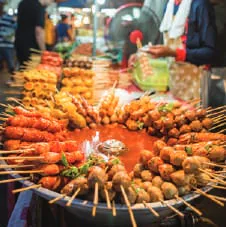 Skewers of street food on a grill