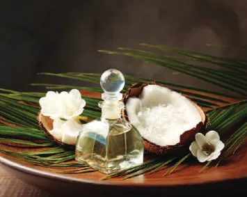 Coconut halves and oil in a glass jar