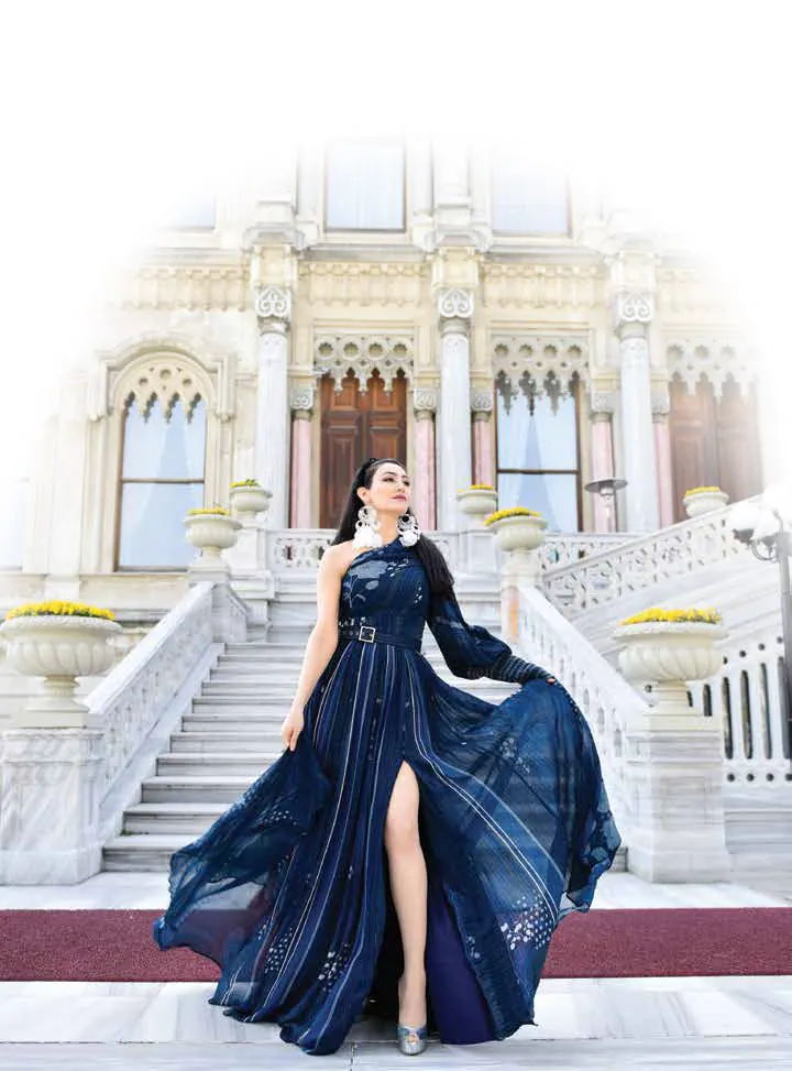 Shalini Passi in a flowing blue gown on the steps of a palace