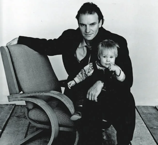 Black-and-white photograph of Sting holding his young daughter