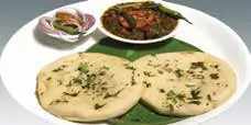 Kulchas and a curry served on a plate