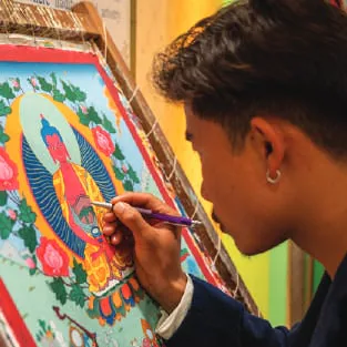 An artist painting a thangka