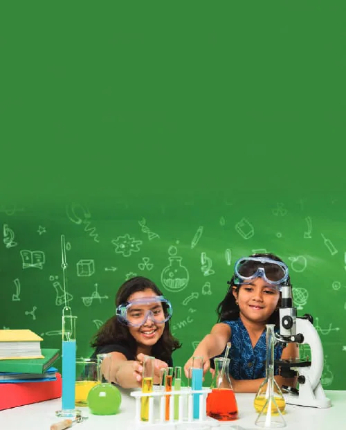 Two girls in lab goggles doing a science experiment