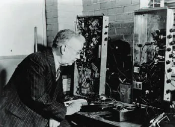 Black-and-white photograph of a man at early radio equipment