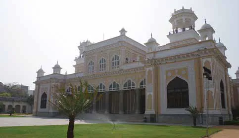 An arched stone building with ornamental towers