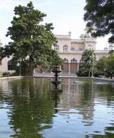 A palace seen across a pond among trees
