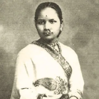 A vintage portrait of a woman in a sari and jewellery