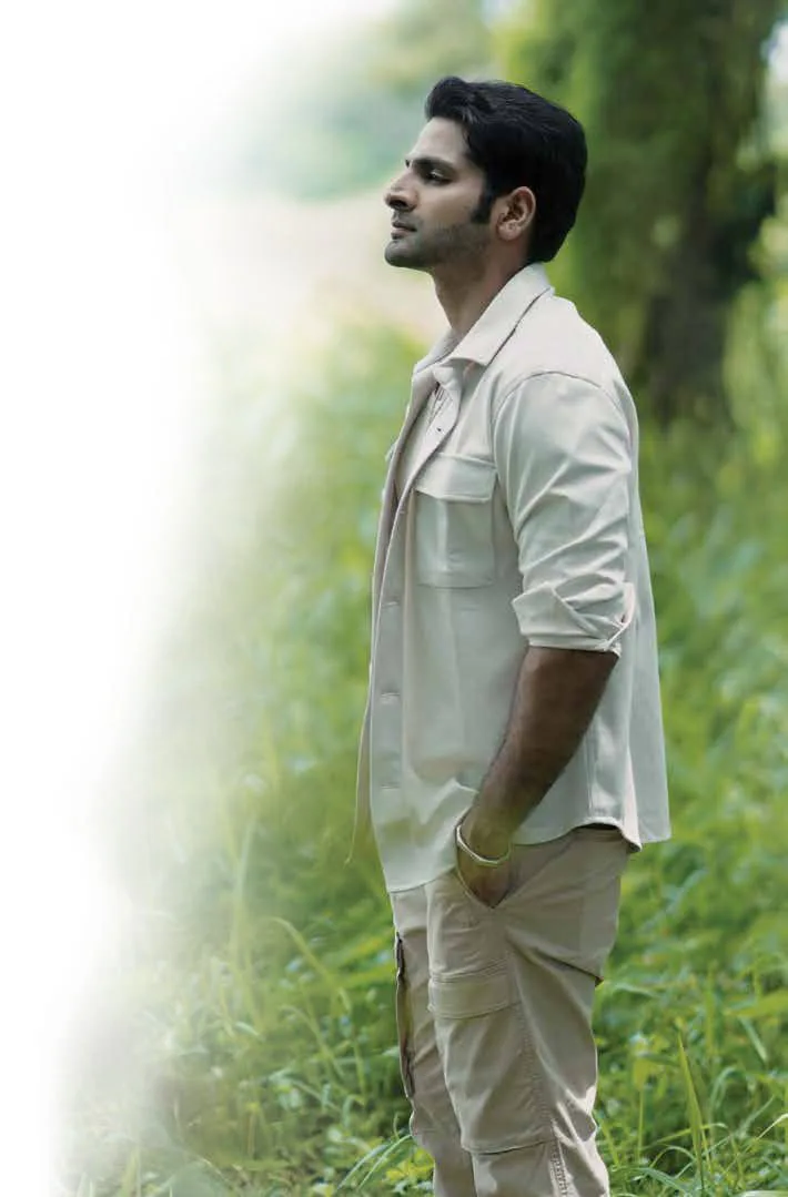 Vaibhav Tatwawadi in a beige shirt standing among trees