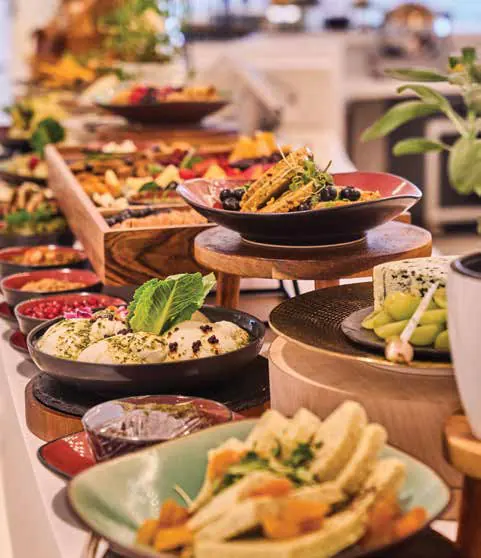 A breakfast buffet of plated dishes