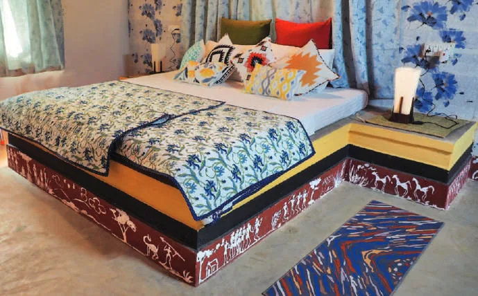 A bedroom with a block-printed bedspread