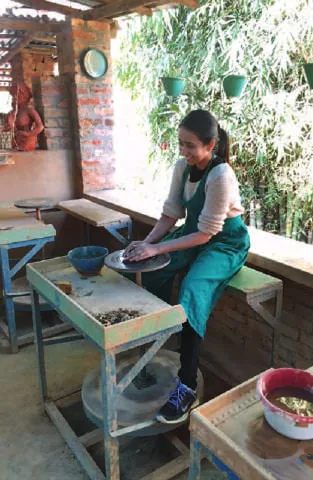 A woman working at a potter’s wheel