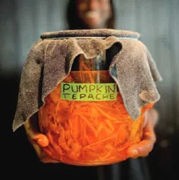 A cloth-covered jar labelled Pumpkin Tepache
