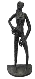 A dark metal sculpture of a standing figure