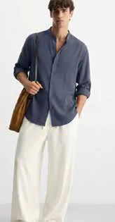 A man in a loose linen shirt and trousers