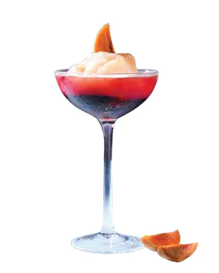 A sorbet cocktail in a stemmed glass, garnished with fruit