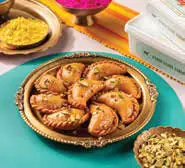 A plate of gujiyas on a festive table