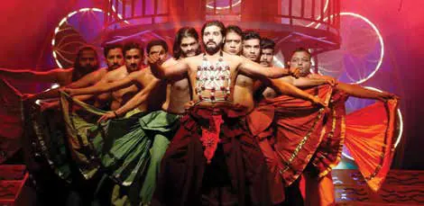 Actors performing on a stage in red light