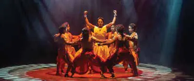 Dancers performing on a stage in red light