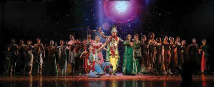Dancers performing on stage in a large ensemble