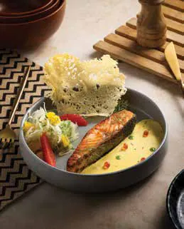 A plated dish of fish on a restaurant table