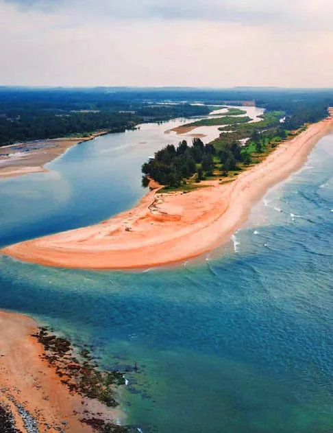 A river meeting the sea beside a sandbar